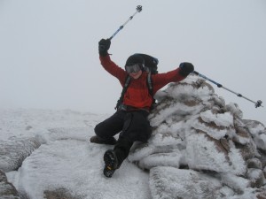 Alfie celebrating in the wind at the top of Cnap Coire na Spreidhe